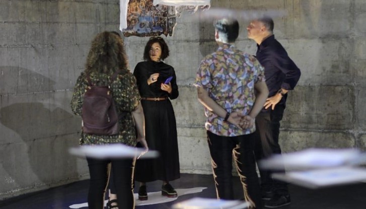 Ambassador Elsa Håstad talking to exhibition curator and others