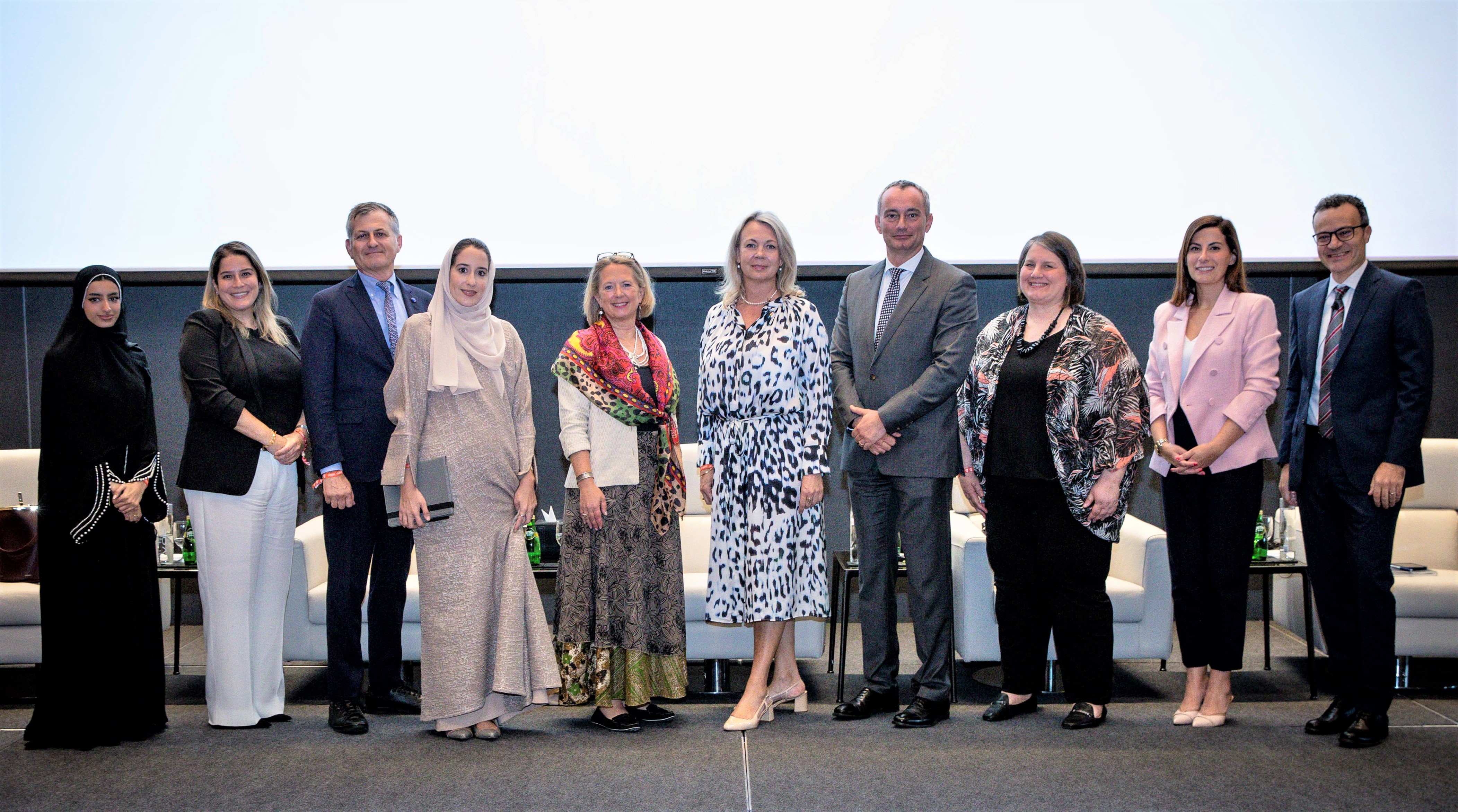 Panellists and speakers gathering for a group photo after the event