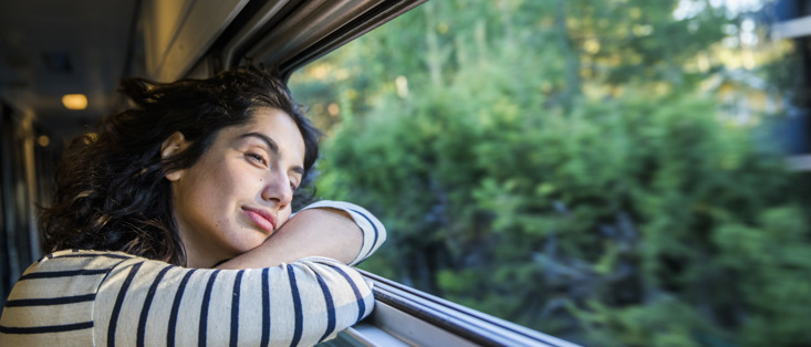 Woman looking out a train window